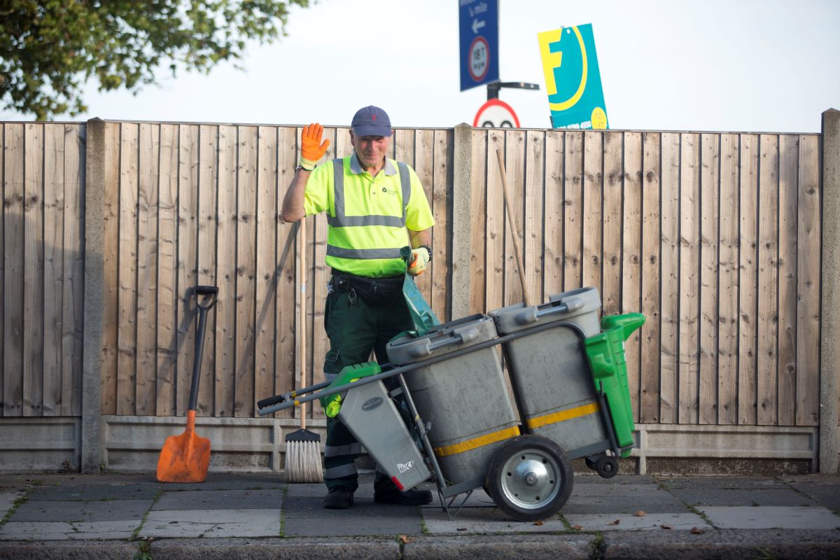 Smiling street sweeper in Ealing